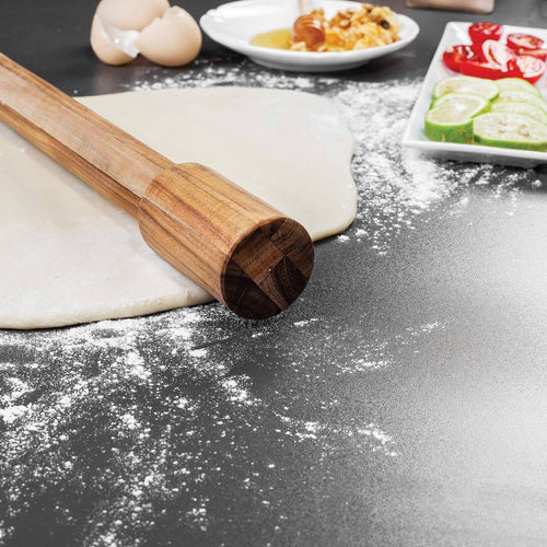 Handcrafted acacia wood rolling pin with fixed handles resting on rolled dough dusted with flour, surrounded by ingredients for baking, ideal for Kitchen & Food, Cookware, Baking Supplies, Best Sellers, and Promo Eligible collections.