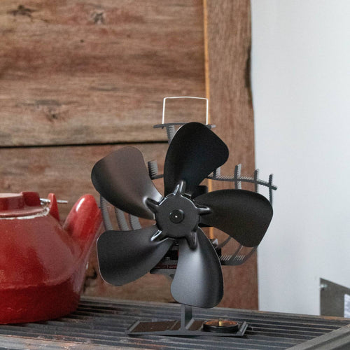 Black handcrafted heat-powered oscillating stove fan with five curved blades and protective guard, designed to distribute warm air efficiently from wood-burning stoves, ideal for use in stoves and hearth accessories collections.