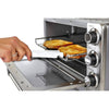 Hand gripping a white toaster tong with serrated teeth lifting toast from a metal oven rack in a compact stainless steel toaster oven, part of Kitchen Gadgets and Cooking and Baking Helpers collections.
