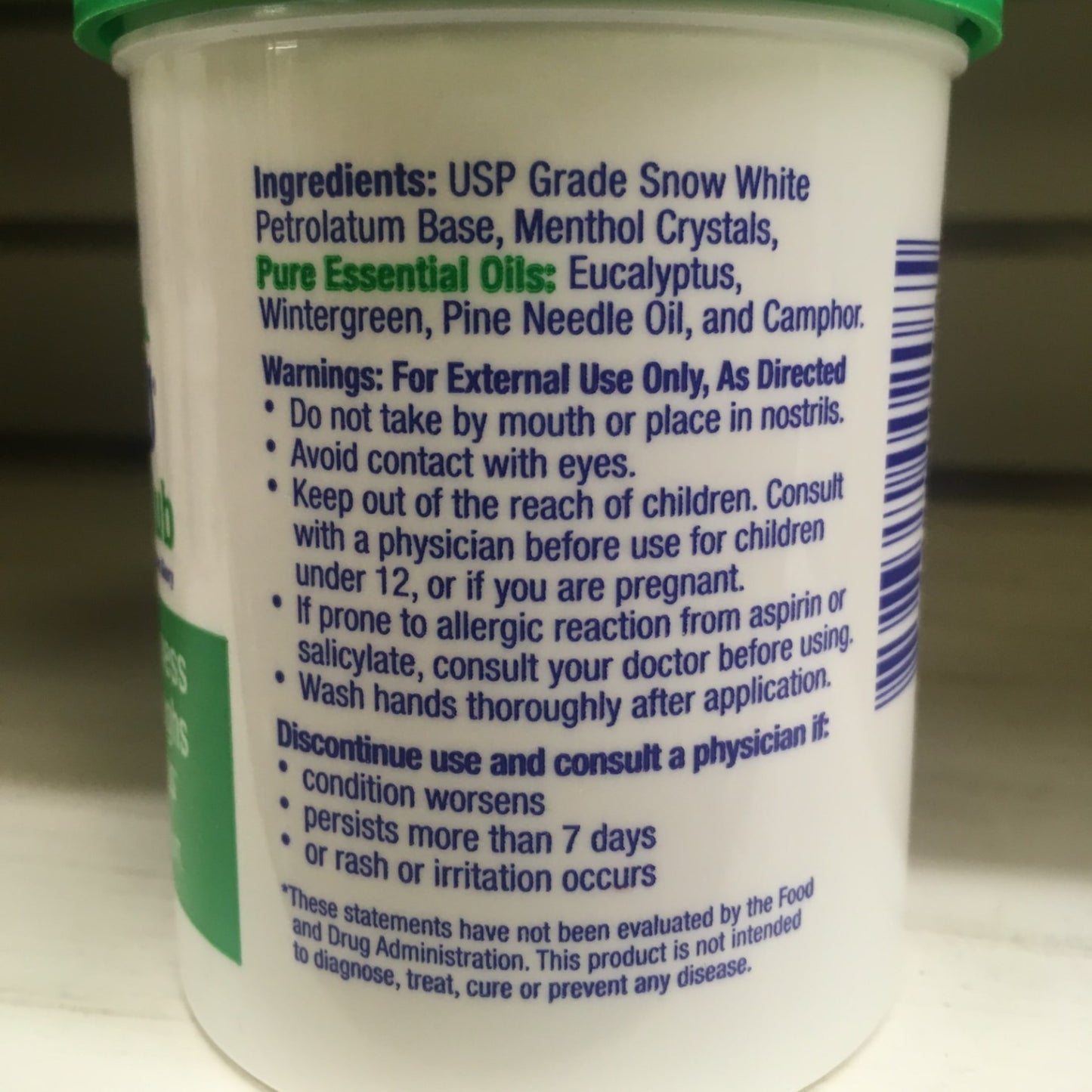Close-up of a handcrafted therapeutic rub container showing ingredients including menthol crystals and pure essential oils like eucalyptus and camphor, with detailed usage warnings, made in USA, featured in Health & Wellness, Health Remedies, USA Made, Best Sellers, and Promo Eligible collections.