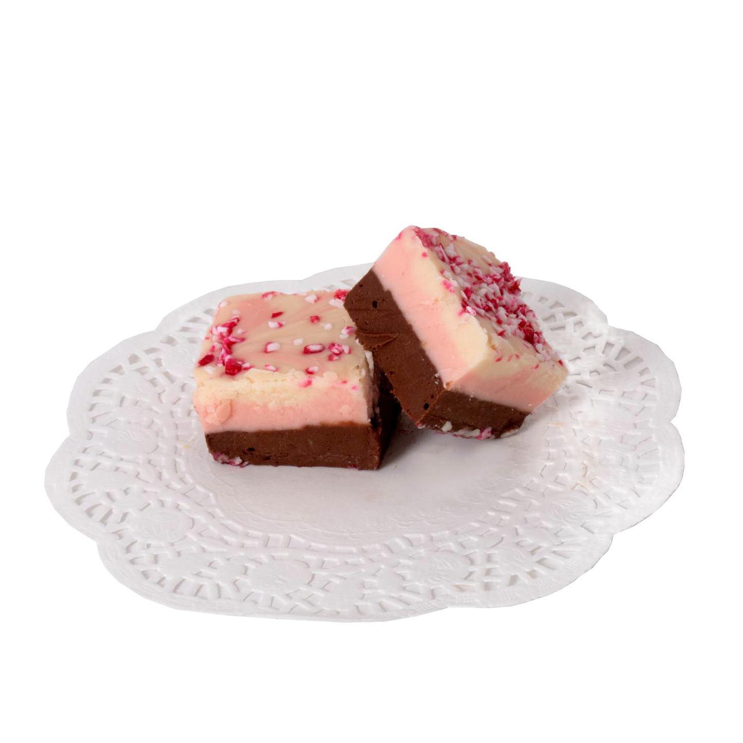 Two handcrafted peppermint-topped fudge pieces with layered creamy chocolate and vanilla flavors, presented on a white lace paper doily, part of USA made Snacks and Sweets collections.