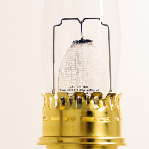 Close-up of a handcrafted solid brass wall-mounted oil lamp mantle glowing brightly, featured in Farm, Garden & Tool, Emergency Supplies, and Lamps & Lighting collections.