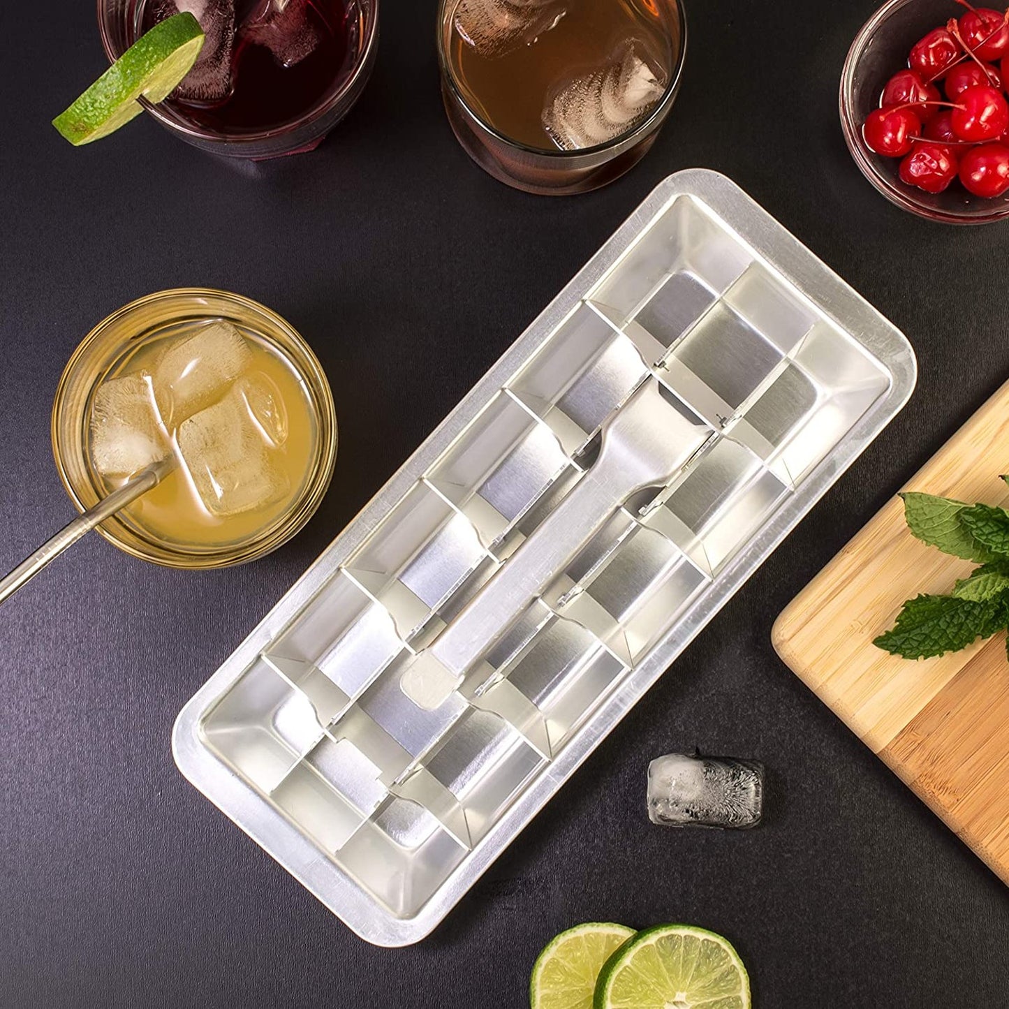 Handcrafted aluminum ice cube tray with removable divider and release handle, surrounded by drinks, lime slices, and cherries, ideal for Farm, Garden & Tool and Kitchen Gadgets collections.