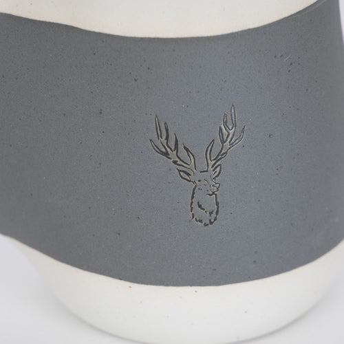Handcrafted gray ceramic mug with a white base and embossed stag design on the front, featuring a cozy handwarmer pocket, ideal for Kitchen & Food, Dinnerware, and Best Sellers collections.