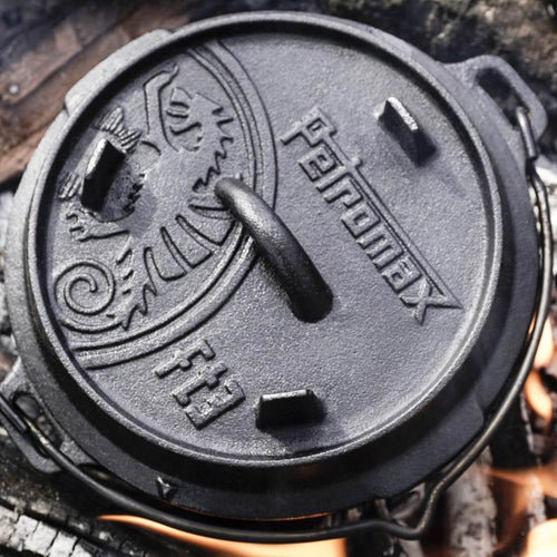 Close-up of a sturdy cast iron Dutch oven lid embossed with the Petromax logo and decorative details, crafted for durable outdoor and indoor cooking, featured in Kitchen & Food, Cookware, Cast Iron, Best Sellers, and Promo Eligible collections.