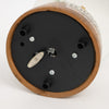 Bottom view of handcrafted musical snow globe base showing winding key, black plastic with three support feet, part of holiday decor and best sellers collections.