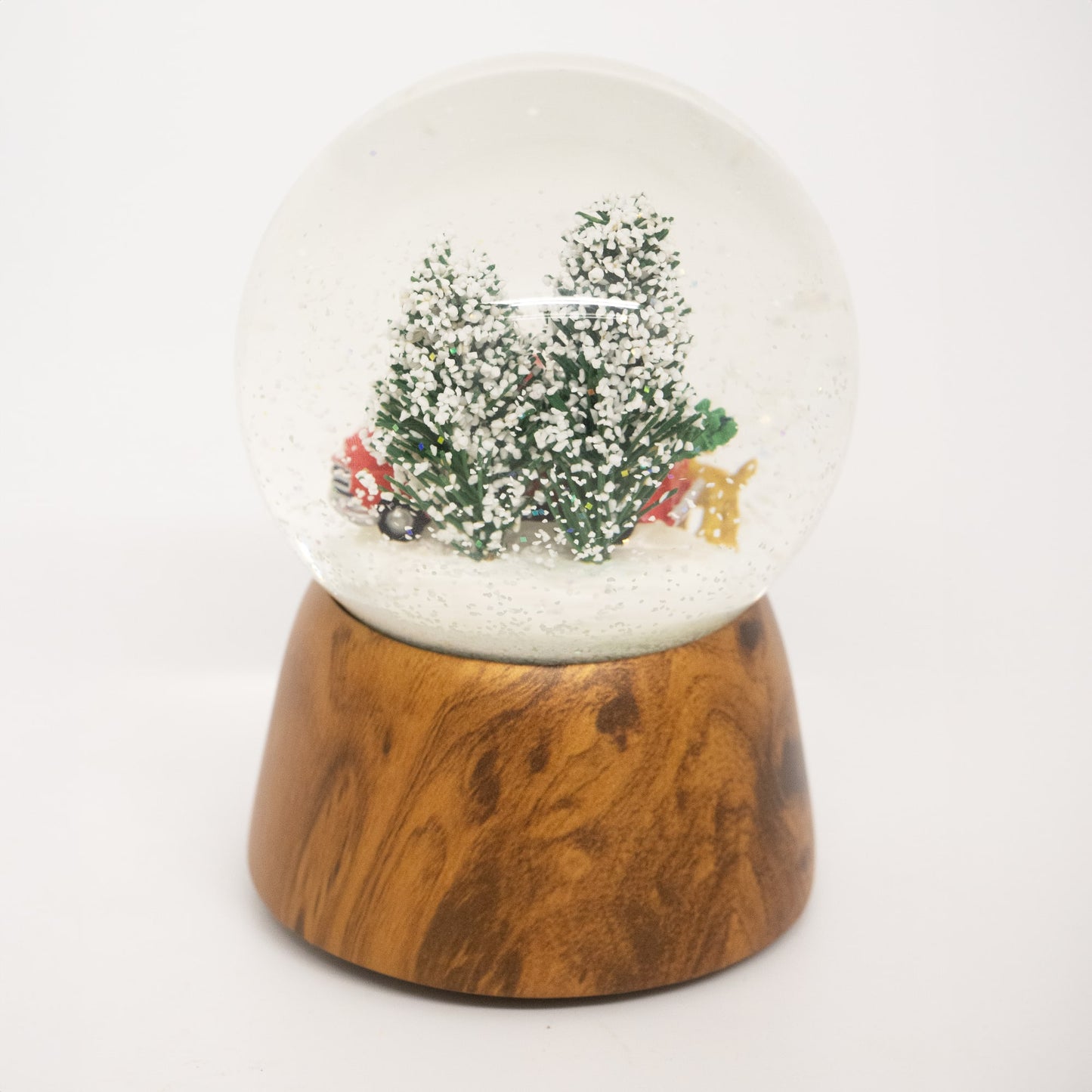 Handcrafted musical snow globe with a red truck, Christmas tree, and two dogs in a snowy scene on a wooden base, ideal for Home & Decor, Holiday Decor, and Best Sellers.