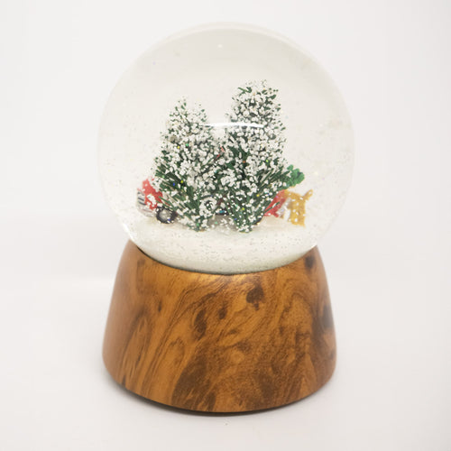 Handcrafted musical snow globe with a red truck, Christmas tree, and two dogs in a snowy scene on a wooden base, ideal for Home & Decor, Holiday Decor, and Best Sellers.