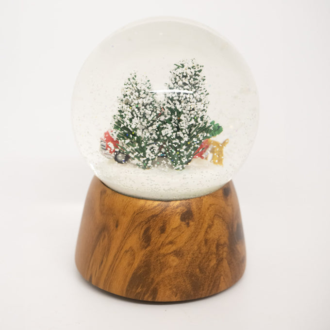 Handcrafted musical snow globe with a red truck, Christmas tree, and two dogs in a snowy scene on a wooden base, ideal for Home & Decor, Holiday Decor, and Best Sellers.