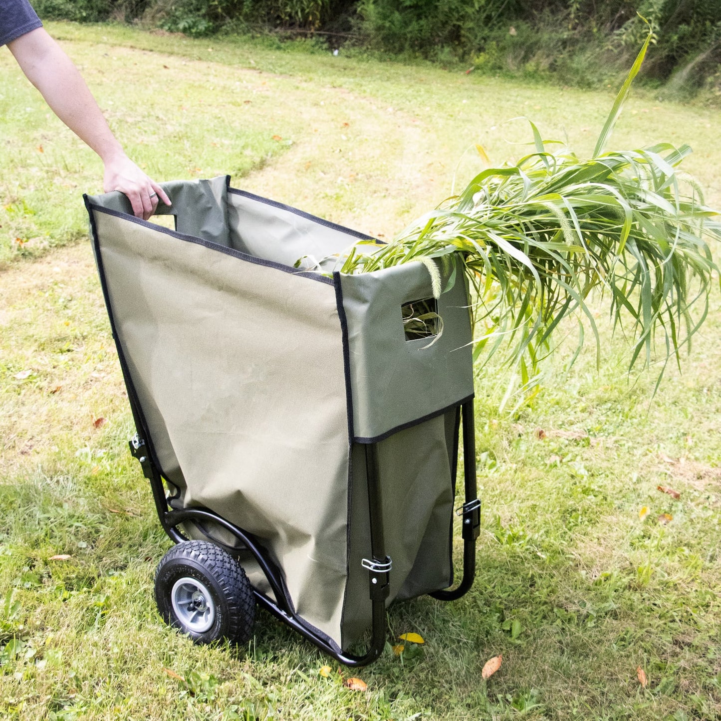 Durable foldable garden cart with olive-colored fabric liner and sturdy black steel frame, featuring large rugged wheels and handle cutouts, ideal for hauling yard debris in Farm, Garden & Tool collections.