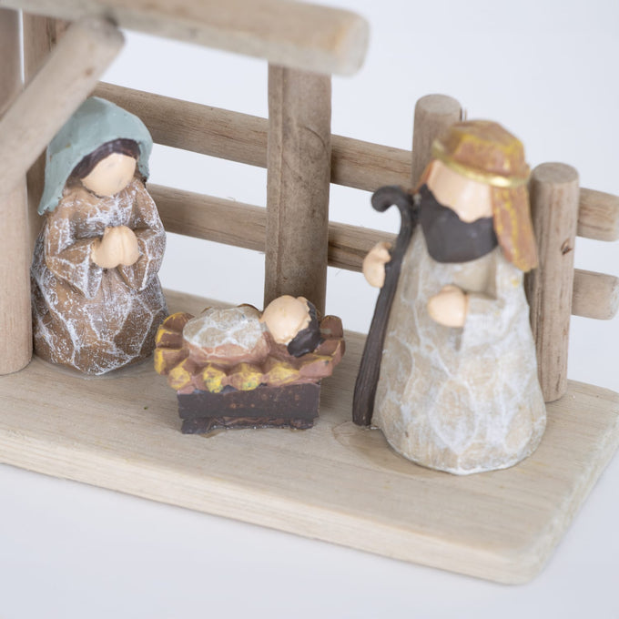 Handcrafted small nativity set with wood stable and attached resin figures of Mary, Joseph, and baby Jesus, designed for easy display in Home & Decor, Holiday Decor, and Best Sellers collections.