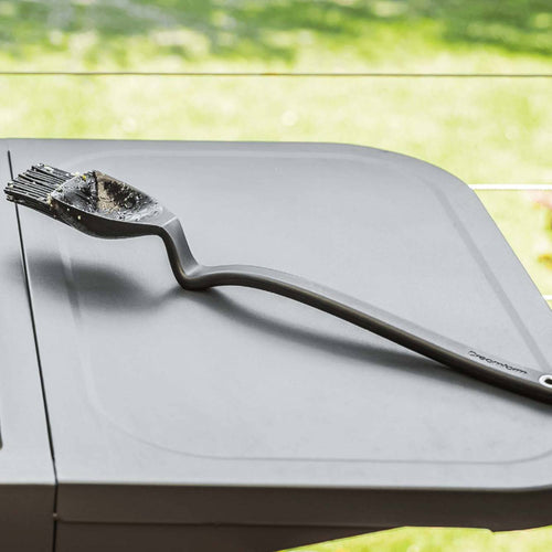Black basting brush with a uniquely angled handle and deep flexible scooping head designed for efficient sauce application, ideal for Kitchen Gadgets and Grilling collections.