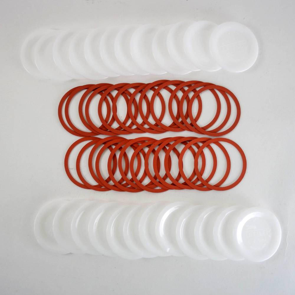 Handcrafted reusable white plastic canning jar lids and red sealing rings designed for regular mouth jars, made in USA, ideal for Kitchen & Food, Food Preservation, and Canning collections.