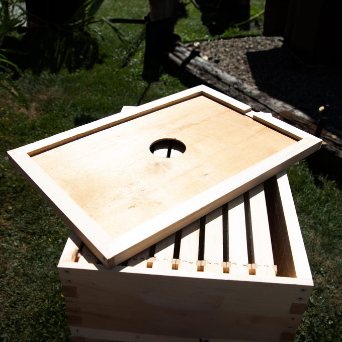 Handcrafted Amish made wooden hive inner cover with a centered ventilation hole, designed for moisture control and airflow, ideal for beekeeping and farm supplies.