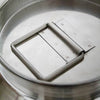 Close-up of a seamless 304 grade stainless steel milk can lid with a sturdy square handle, showcasing durable construction for easy use and cleaning in farm, garden, and animal care collections.