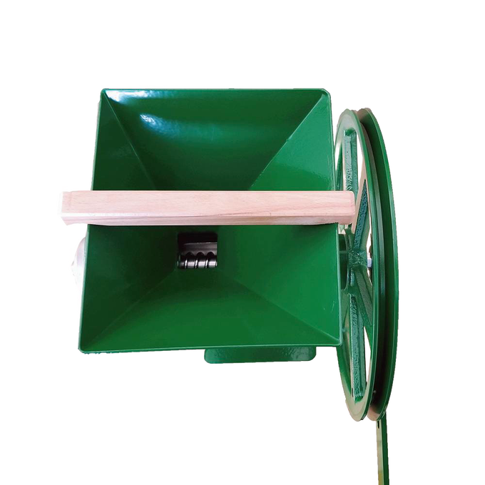 Top view of a handcrafted green milling hopper with a large wooden hand crank attached to a cast iron grinding wheel, designed for homesteading, kitchen, and emergency supplies collections.