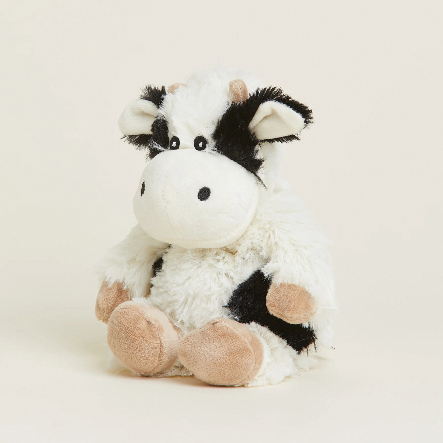 Soft and cuddly black and white plush cow with tan hooves and small horns, weighted and microwaveable for cozy warmth, ideal for Health & Wellness and Children's Toys collections.