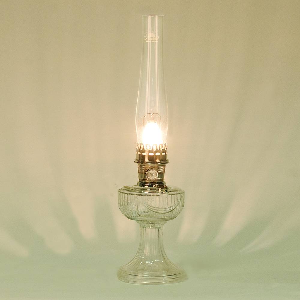 Handcrafted clear glass lamp with an embossed drape pattern, featuring a bright brass burner and tall chimney, part of Lamps & Lighting, Oil Lamps, Table Lamps, Best Sellers, and Promo Eligible collections.