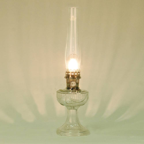 Handcrafted clear glass lamp with an embossed drape pattern, featuring a bright brass burner and tall chimney, part of Lamps & Lighting, Oil Lamps, Table Lamps, Best Sellers, and Promo Eligible collections.