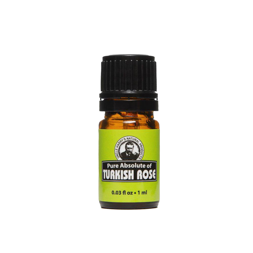 Small amber glass bottle with black cap containing pure Turkish rose absolute oil, featuring a green label with text and an illustrated portrait, part of Health & Wellness and USA Made collections.