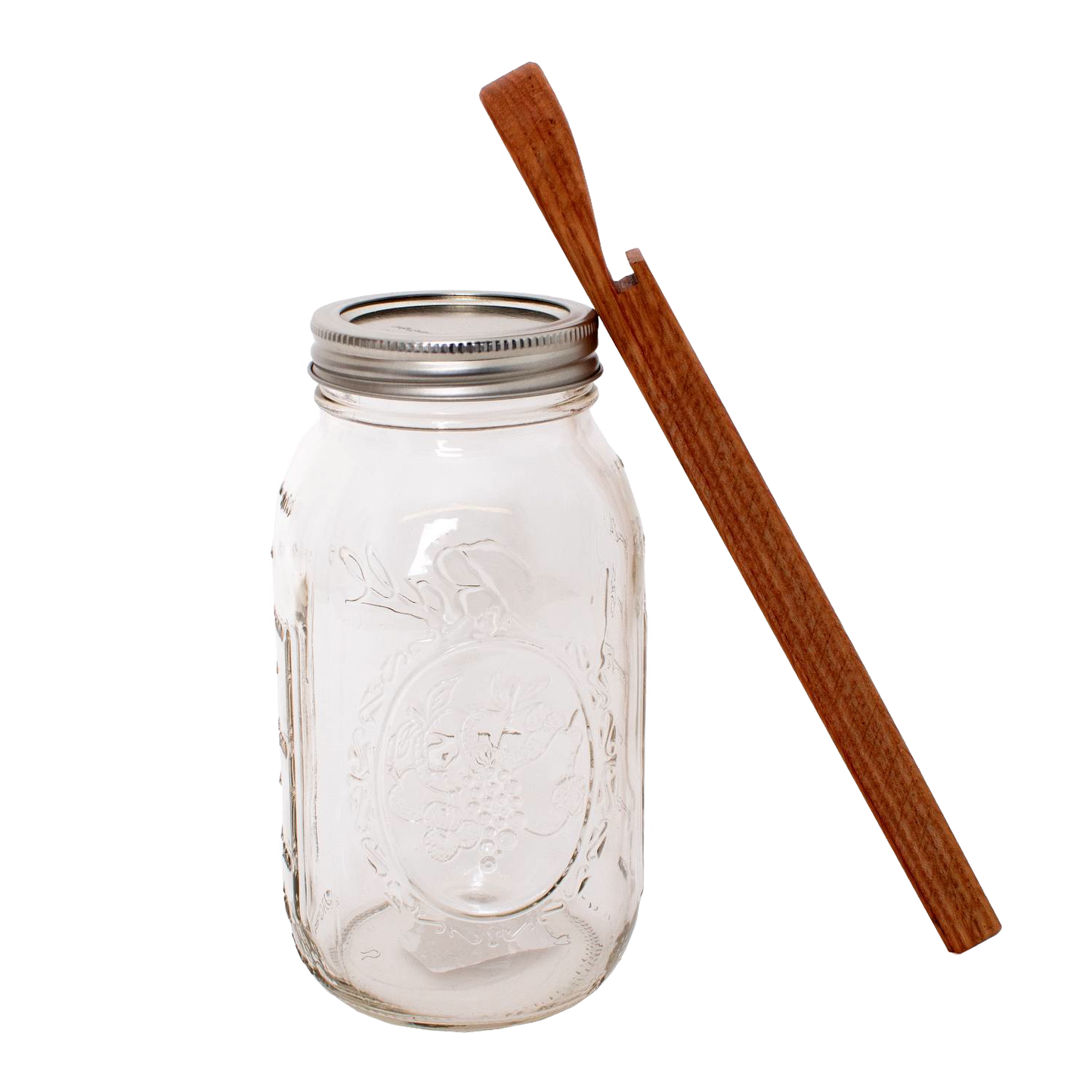 Handcrafted oak jar opener beside a clear mason jar with metal lid, designed for easy seal removal without damaging lids, featured in Kitchen & Food and Canning Accessories collections.