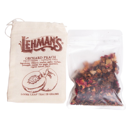 Clear resealable pouch filled with handcrafted loose leaf orchard peach fruit tea blend alongside a natural fabric drawstring bag, a USA made beverage from Kitchen & Food collections.
