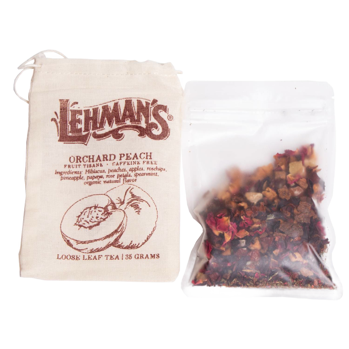 Clear resealable pouch filled with handcrafted loose leaf orchard peach fruit tea blend alongside a natural fabric drawstring bag, a USA made beverage from Kitchen & Food collections.