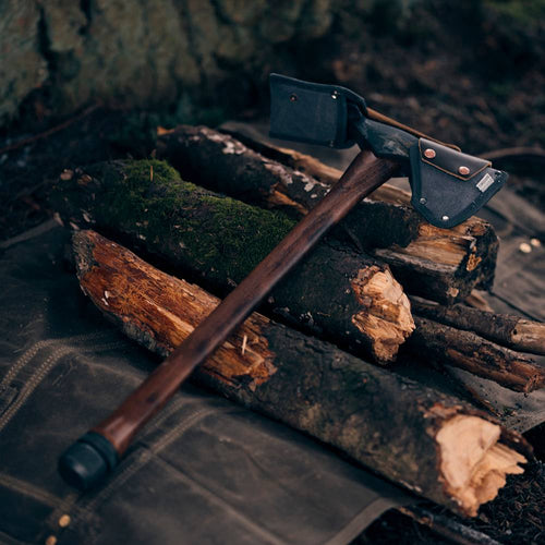 Pulaski axe with a hand-sharpened 1055 high carbon steel head and mattock blade, featuring a smooth wooden handle and protective canvas sheath, suited for farm, garden, and wood hauling tasks.