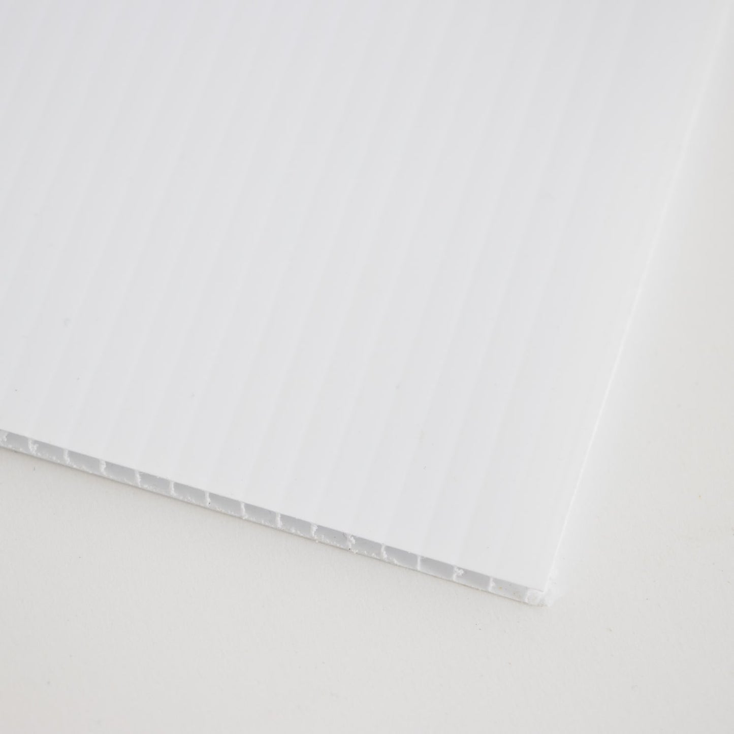 Close-up of a white Coroplast board crafted in the USA, Amish made, designed to slide easily into 5-frame hive screen bases for monitoring mites, featured in beekeeping and farm tool collections.