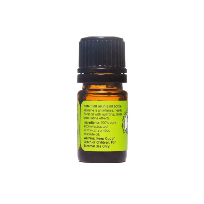 Small amber glass bottle with black cap containing Jasmine Absolute Oil, featuring a green label with usage notes and safety warnings, handcrafted and made in USA.