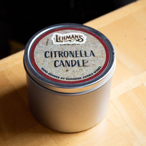 Compact hand-poured citronella candle in a silver tin with a rustic label, handcrafted and ideal for outdoor use in camping, pest control, and garden lighting collections.