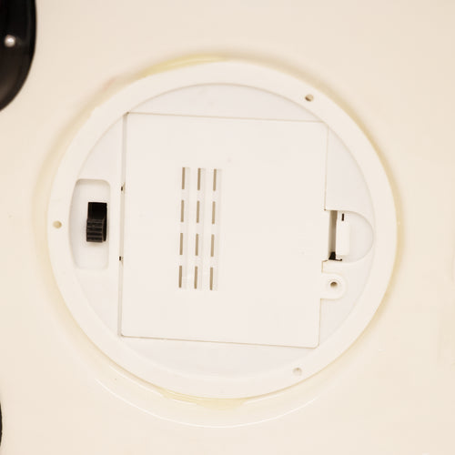 Close-up of a white battery compartment with a sliding lock and ventilation slits, handcrafted for use in Home & Decor, Holiday Decor, Best Sellers, and Promo Eligible collections.