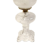 Handcrafted clear glass oil lamp featuring an intricately sculptured base with a heavy brass-plated burner and etched white glass chimney, ideal for Lamps & Lighting, Oil Lamps, Table Lamps, Best Sellers, and Promo Eligible collections.
