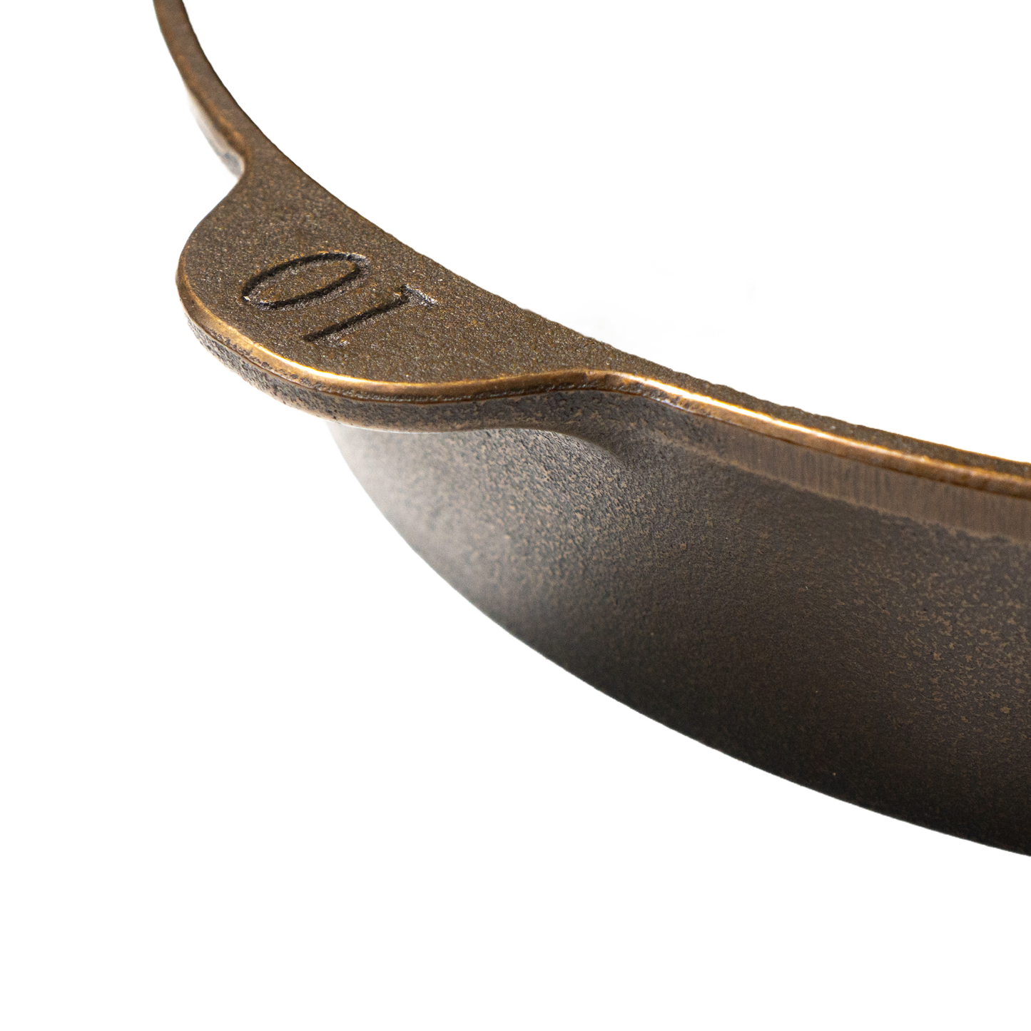 Close-up of the outer edge of a handmade, USA-made cast iron skillet with size number 10 embossed, featuring a textured exterior perfect for Kitchen & Food, Camping, and Cast Iron collections.