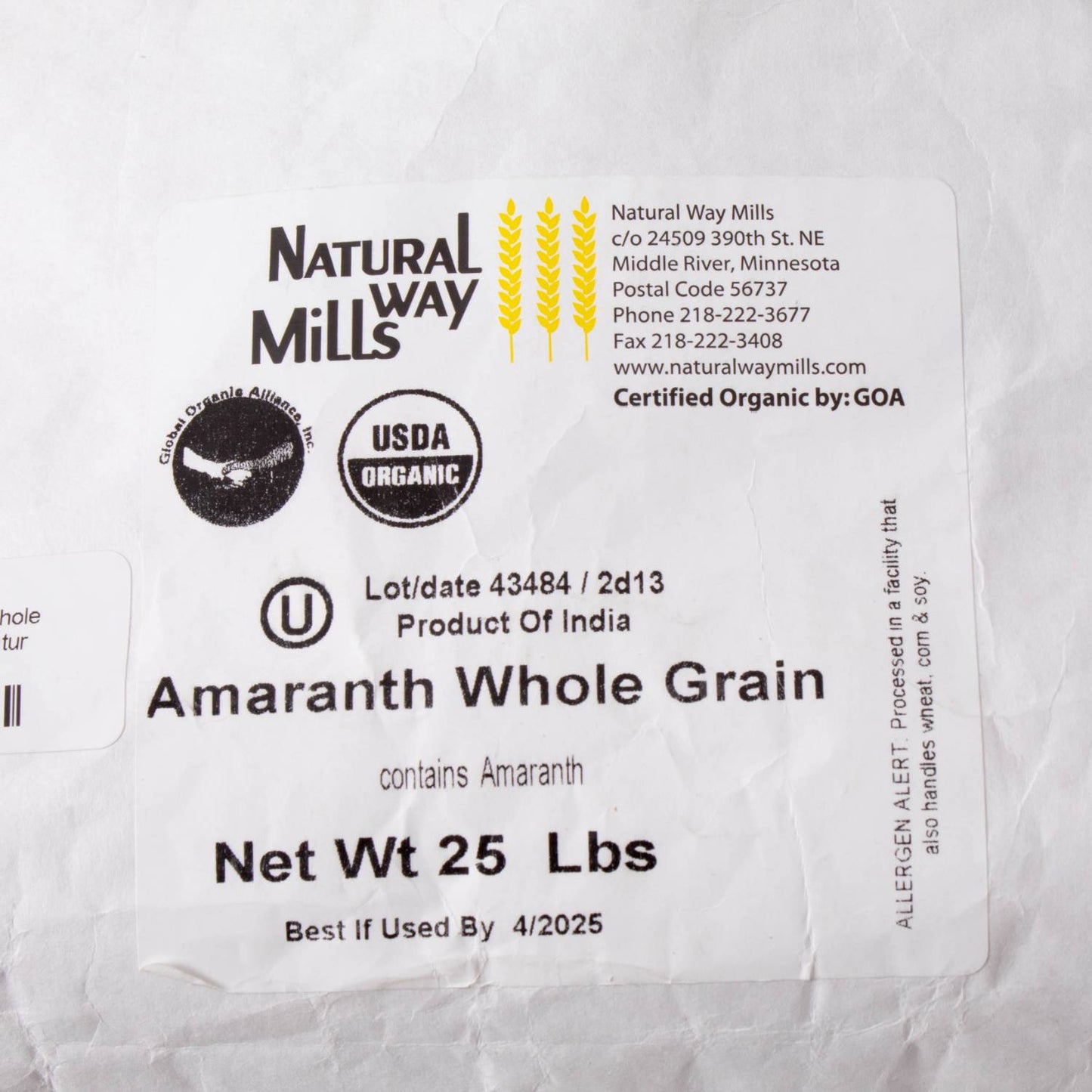 Close-up view of a white sack label for organic whole amaranth grain, highlighting certified organic packaging for pantry, farm, and emergency food supplies collections.