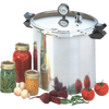 Large stainless steel pressure canner with secure locking lid, pressure gauge, and black handles, accompanied by jars of preserved vegetables and fresh produce, ideal for kitchen canning and food preservation collections.