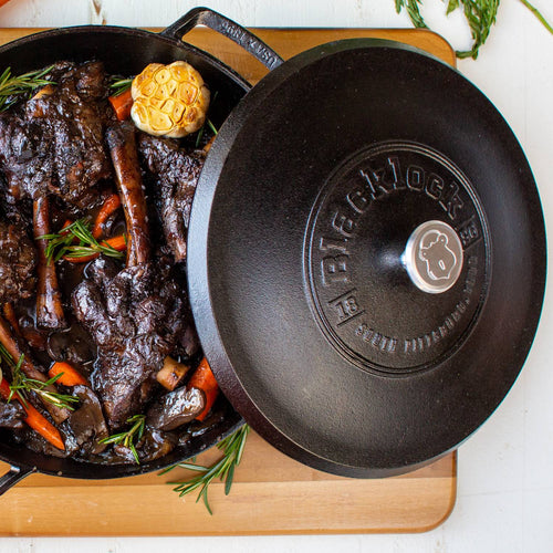 Lightweight cast iron braiser with secure lid featuring embossed branding, holding tender cooked meat and vegetables, handcrafted in USA, ideal for Kitchen & Food, Cookware, Cast Iron collections.