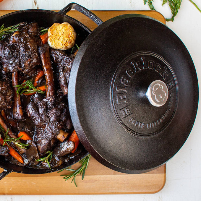 Lightweight cast iron braiser with secure lid featuring embossed branding, holding tender cooked meat and vegetables, handcrafted in USA, ideal for Kitchen & Food, Cookware, Cast Iron collections.