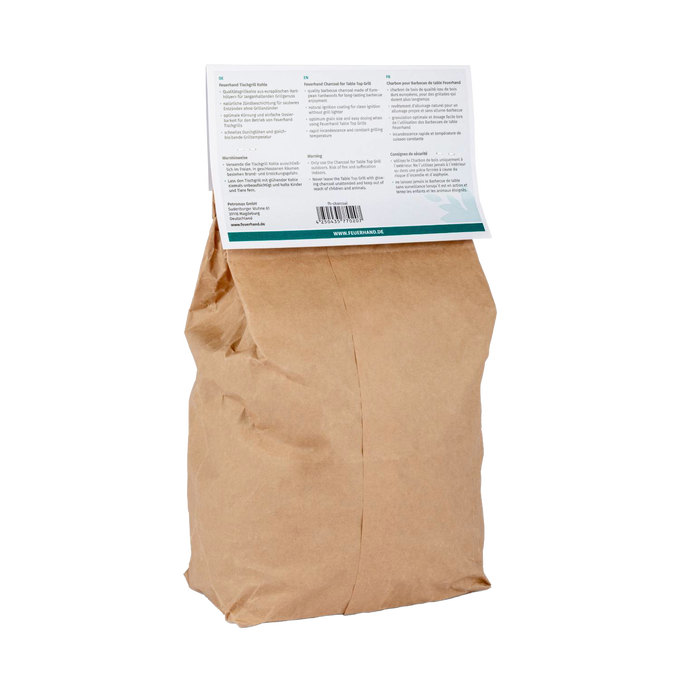 Brown paper bag of charcoal for tabletop grilling with a folded information label, ideal for grilling enthusiasts and featured in Stoves, Grilling, Best Sellers, and Promo Eligible collections.