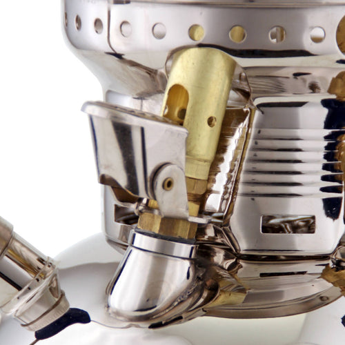 Close-up of the polished metal and brass components on a handcrafted Petromax HK500 kerosene pressure lamp, highlighting its durable design for camping, farm, and emergency use.