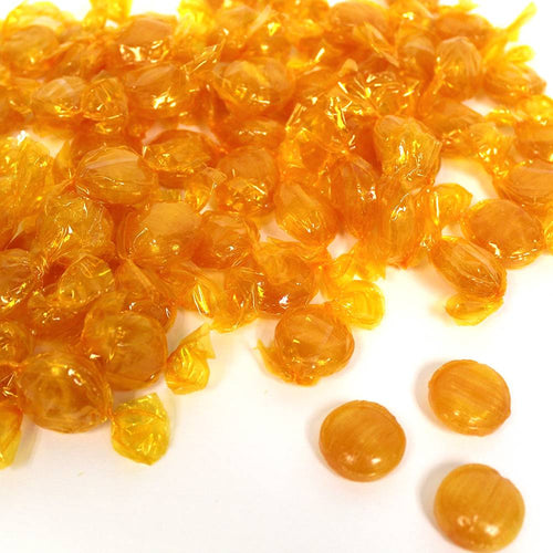 Individually wrapped butterscotch candies in golden amber tones scattered on a white background, handcrafted and made in USA, featured in Kitchen & Food, Snacks and Sweets, Candy, Best Sellers, and Promo Eligible collections.