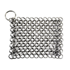 Handcrafted chainmail scrubber made of interlinked stainless steel rings with a keyring loop, designed for gently cleaning cast iron cookware and kitchen surfaces.