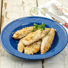Cooked chicken tenders seasoned and arranged on a speckled blue enamel plate, garnished with fresh parsley, set on rustic wooden surface with cutlery in the background.