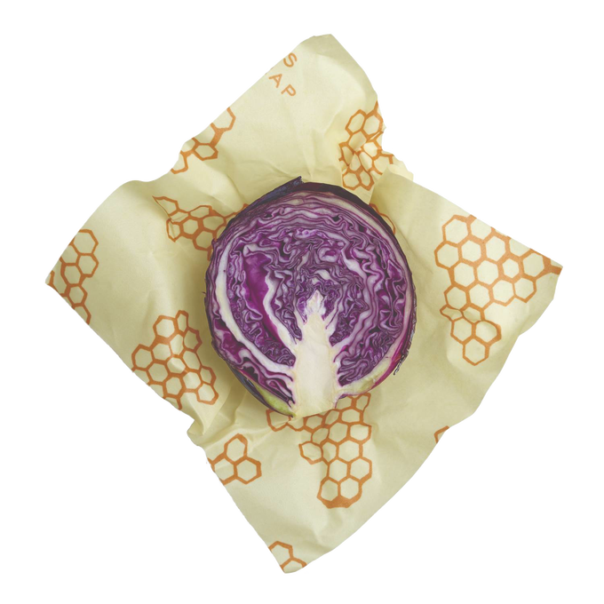 Large handmade beeswax wrap with honeycomb pattern enclosing a halved purple cabbage, ideal for eco-friendly food storage in Kitchen & Food, Storage and Serving, USA Made, and Best Sellers collections.