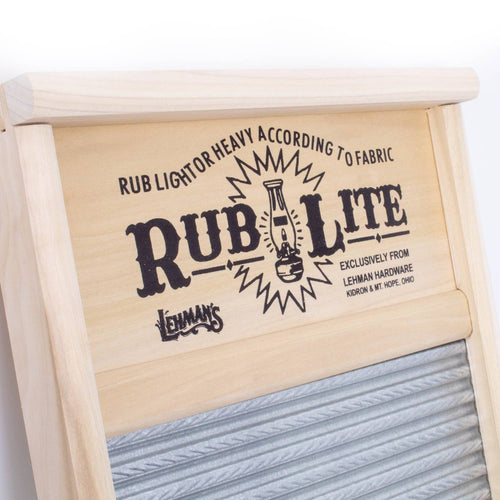 Close-up of a handcrafted wooden washboard featuring a decorative printed nameplate with vintage-style text and a spiral crimped metal wash surface, made in the USA for effective laundry use in home and decor collections.