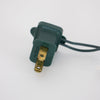 Close-up of a green two-prong electrical plug with attached cord, suitable for indoor use and compatible with lighted holiday decorations in Home & Decor and Promo Eligible collections.