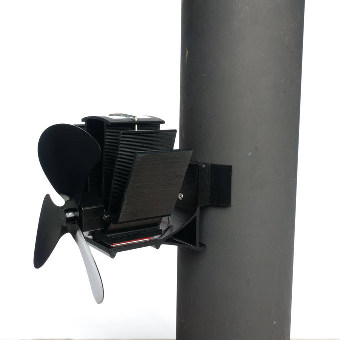 Black heat-powered magnetic stove fan with three blades, mounted on a flue pipe, designed for efficient warm air circulation; featured in Hearth Accessories and Best Sellers collections.