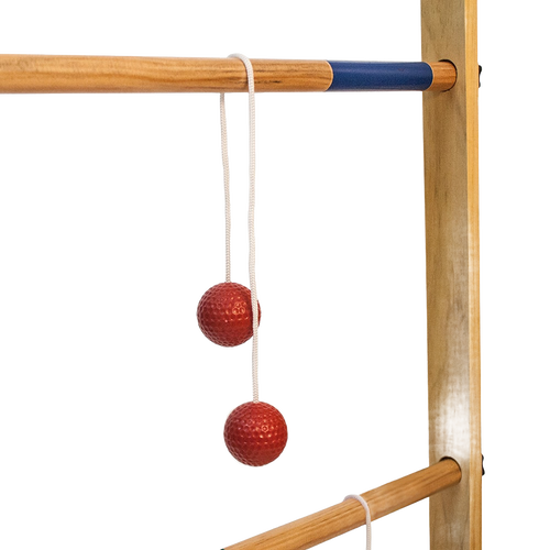 Close-up of a handcrafted wooden ladder frame with natural finish and blue accent rung, featuring red golf ball bolas hanging by white cords, ideal for lawn games collections.