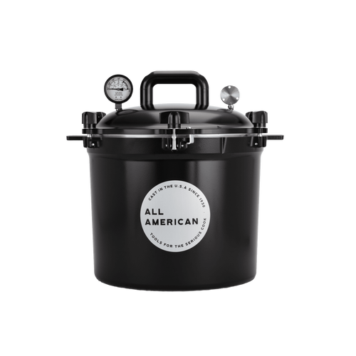Black pressure canner with secure locking lid, built-in pressure gauge, and heavy-duty handle, designed for safe and reliable food preservation in USA Made kitchen and canning collections.