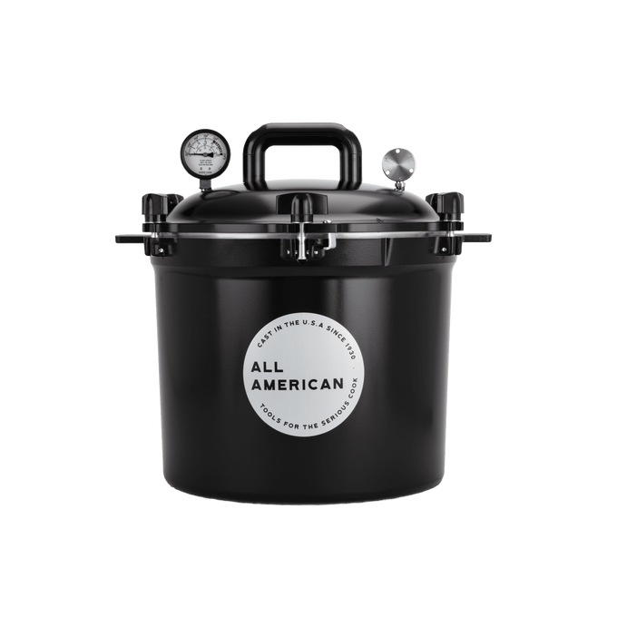 Black pressure canner with secure locking lid, built-in pressure gauge, and heavy-duty handle, designed for safe and reliable food preservation in USA Made kitchen and canning collections.